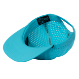 Bright turquoise baseball cap with white polka dot interior lining.