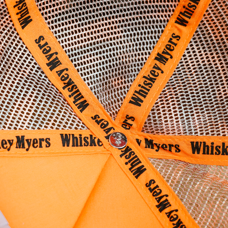 Umbrella with orange panels and ’Whiskey Myers’ printed on the ribs.