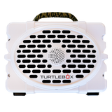 White portable speaker with a perforated front grille and ’TURTLEBOX’ branding.