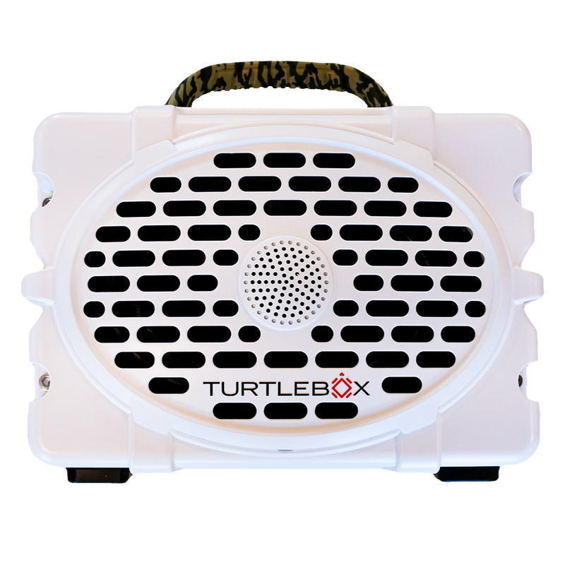 White portable speaker with a perforated front grille and ’TURTLEBOX’ branding.