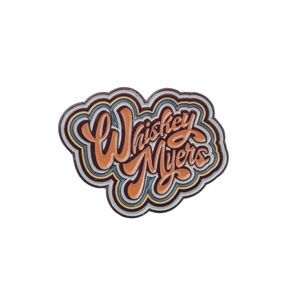 Retro-style enamel pin or patch featuring the text ’Washed Ashore’ in groovy, multi-layered lettering.